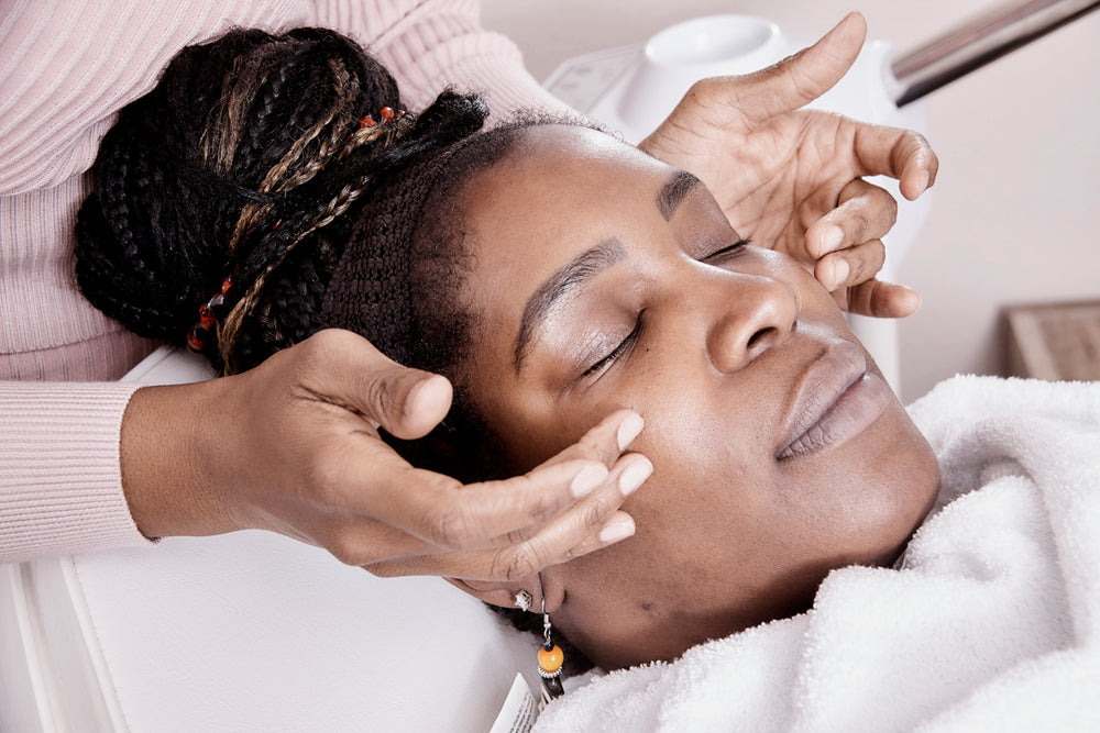 Black woman getting a skin treatment or facial from Ayanna Denise